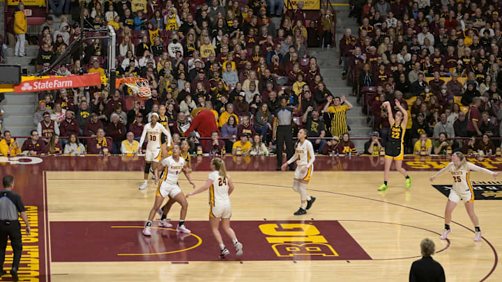 Feb 28, 2024; Minneapolis, Minnesota, USA; Iowa Hawkeyes guard Caitlin Clark (22) hits a three-pointer against the Minnesota Golden Gophers during the fourth quarter at Williams Arena. Mandatory Credit: Nick Wosika-Imagn Images