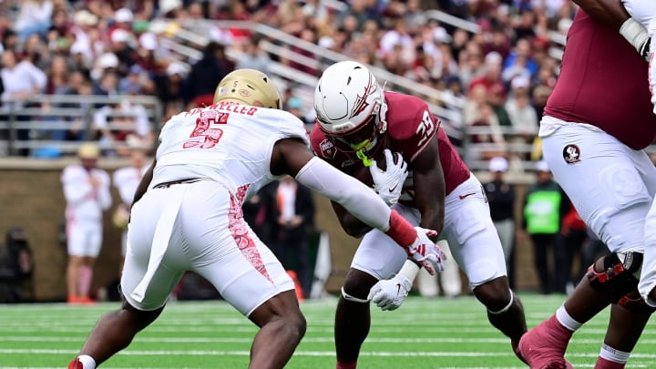 Sep 16, 2023; Chestnut Hill, Massachusetts, USA; Boston College Eagles linebacker Kam Arnold (5) tackles Florida State Seminoles running back Rodney Hill (29) during the first half at Alumni Stadium.