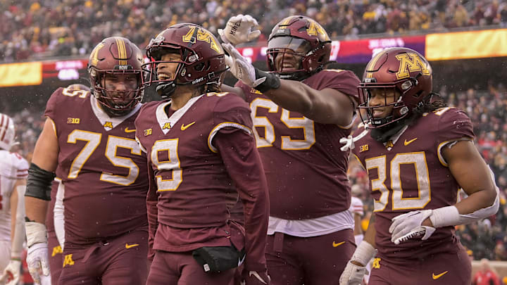 Offensive lineman Tyler Cooper (75) celebrates a Minnesota touchdown against Wisconsin.
