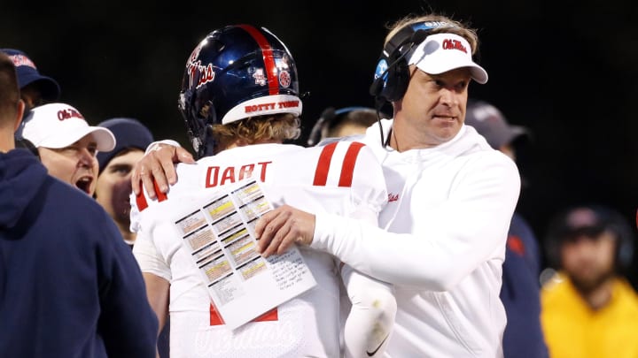 Nov 23, 2023; Starkville, Mississippi, USA; Mississippi Rebels head coach Lane Kiffin reacts with quarterback Jaxson Dart (2) after a touchdown during the second half against the Mississippi State Bulldogs at Davis Wade Stadium at Scott Field. Mandatory Credit: Petre Thomas-USA TODAY Sports