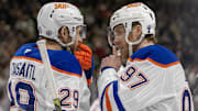 Jan 15, 2025; Saint Paul, Minnesota, USA;  Edmonton Oilers forward Leon Draisaitl (29) and forward Connor McDavid (97) talk before a face-off against the Minnesota Wild during the third period at Xcel Energy Center. Mandatory Credit: Nick Wosika-Imagn Images

