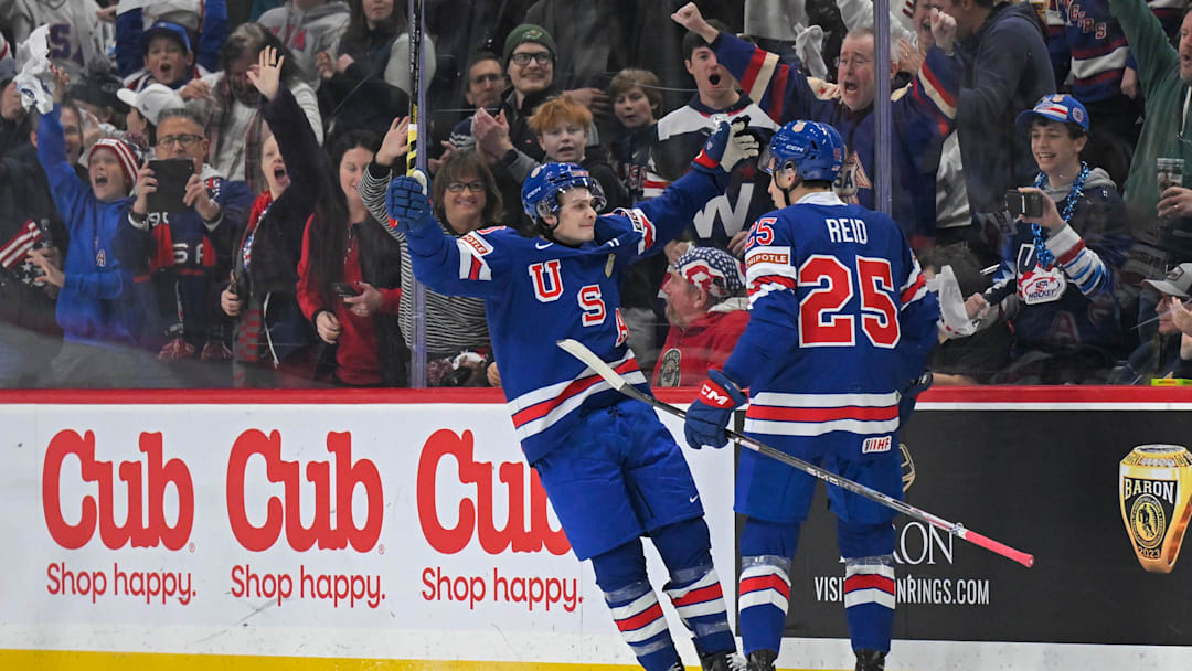 Dec 31, 2025; St. Paul, Minnesota, USA; USA defensemen Chase Reid (25) celebrates his power play goal against Sweden with forward James Hagens (10) during the second period in group play during the 2026 IIHF World Junior Championship at Grand Casino Arena. Mandatory Credit: Nick Wosika-Imagn Images