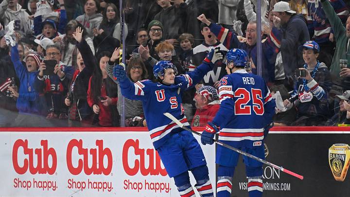 Dec 31, 2025; St. Paul, Minnesota, USA; USA defensemen Chase Reid (25) celebrates his power play goal against Sweden with forward James Hagens (10) during the second period in group play during the 2026 IIHF World Junior Championship at Grand Casino Arena. Mandatory Credit: Nick Wosika-Imagn Images