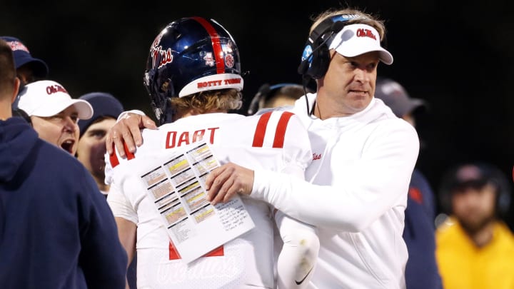 Nov 23, 2023; Starkville, Mississippi, USA; Mississippi Rebels head coach Lane Kiffin reacts with quarterback Jaxson Dart (2) after a touchdown during the second half against the Mississippi State Bulldogs at Davis Wade Stadium at Scott Field. Mandatory Credit: Petre Thomas-USA TODAY Sports