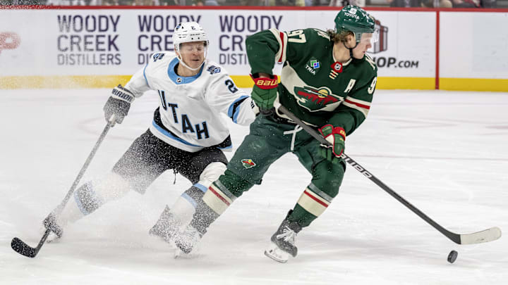 Dec 20, 2024; Saint Paul, Minnesota, USA;  Minnesota Wild forward Kirill Kaprizov (97) controls the puck against Utah Hockey Club defenseman Olli Maatta (2) during the second period at Xcel Energy Center. Mandatory Credit: Nick Wosika-Imagn Images