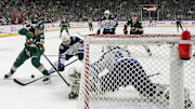 Nov 25, 2024; Saint Paul, Minnesota, USA;  Winnipeg Jets defenseman Neal Pionk (4) poke-check the puck away from Minnesota Wild forward Kirill Kaprizov (97) during the first period at Xcel Energy Center. Mandatory Credit: Nick Wosika-Imagn Images