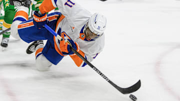 Feb 8, 2025; Saint Paul, Minnesota, USA;  New York Islanders forward Anthony Duclair (11) plays the puck as he falls to the ice against the Minnesota Wild during the third period at Xcel Energy Center. Mandatory Credit: Nick Wosika-Imagn Images