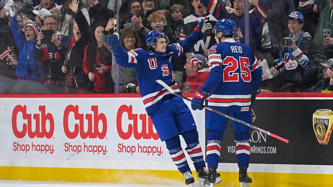 Dec 31, 2025; St. Paul, Minnesota, USA; USA defensemen Chase Reid (25) celebrates his power play goal against Sweden with forward James Hagens (10) during the second period in group play during the 2026 IIHF World Junior Championship at Grand Casino Arena. Mandatory Credit: Nick Wosika-Imagn Images
