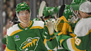 Nov 1, 2024; Saint Paul, Minnesota, USA;  Minnesota Wild forward Matt Boldy (12) celebrates his empty net goal against the Tampa Bay Lightning with goalie Marc-Andre Fleury (29) during the third period at Xcel Energy Center. Mandatory Credit: Nick Wosika-Imagn Images