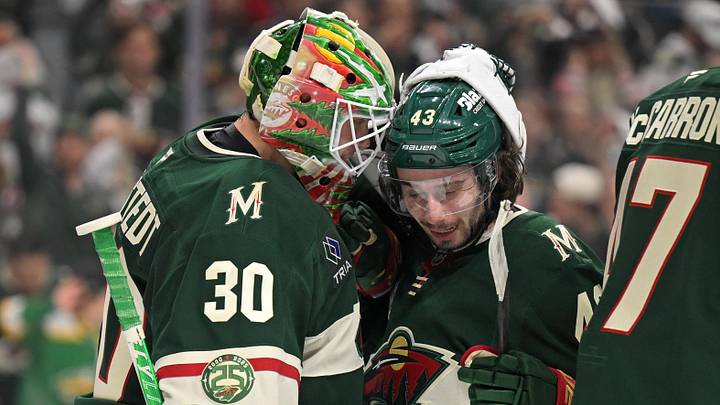 Minnesota Wild goalie Jesper Wallstedt (30) and defensemen Quinn Hughes (43) celebrate a series win against the Dallas Stars after game six of the first round of the 2026 Stanley Cup Playoffs at Grand Casino Arena. Mandatory Credit: Nick Wosika-Imagn Images