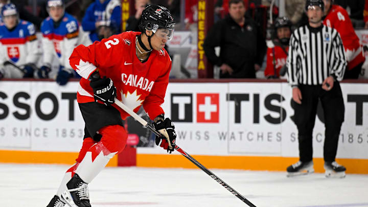 Jan 2, 2026; Minneapolis, Minnesota, USA;  Canada defensemen Kashawn Aitcheson (2) controls the puck against Slovakia during the second period in the quarterfinals of the 2026 IIHF World Junior Championship at 3M Arena. Mandatory Credit: Nick Wosika-Imagn Images