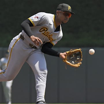 Jul 13, 2025; Minneapolis, Minnesota, USA;  Pittsburgh Pirates infielder Ke'Bryan Hayes (13) fields a ground ball against the Minnesota Twins during the first inning at Target Field. Mandatory Credit: Nick Wosika-Imagn Images
