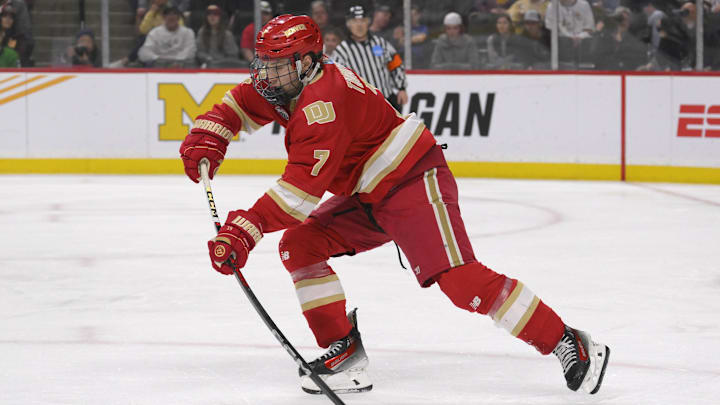 Apr 13, 2024; Saint Paul, Minnesota, USA; Denver Pioneers forward Aidan Thompson (7) makes a pass against the Boston College Eagles during the first period of the championship game of the 2024 Frozen Four college ice hockey tournament at Xcel Energy Center. Mandatory Credit: Nick Wosika-Imagn Images