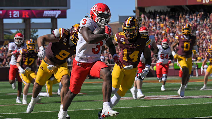 Sep 27, 2025; Minneapolis, Minnesota, USA;  Rutgers Scarlet Knights running back Antwan Raymond (3) runs with the ball as Minnesota Golden Gophers linebacker Devon Williams (9) and defensive back Kerry Brown (14) give chase during the fourth quarter at Huntington Bank Stadium. Mandatory Credit: Nick Wosika-Imagn Images