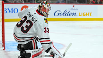Sep 28, 2025; Saint Paul, Minnesota, USA;  Chicago Blckkawks goalie Drew Commesso (33) collects a loose puck against the Minnesota Wild during the second period at Xcel Energy Center. Mandatory Credit: Nick Wosika-Imagn Images
