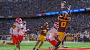 Sep 27, 2025; Minneapolis, Minnesota, USA;  Minnesota Golden Gophers wide receiver Le'Meke Brockington (0) catches an 8-yard pass for a touchdown as Rutgers Scarlet Knights defensive back Bo Mascoe (3) defends during the second quarter at Huntington Bank Stadium.