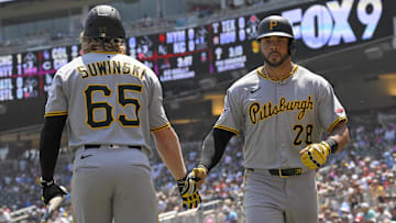 Jul 13, 2025; Minneapolis, Minnesota, USA;  Pittsburgh Pirates outfielder Tommy Pham (28) celebrates his solo home run against the Minnesota Twins with outfielder Jack Suwinski (65) during the second inning at Target Field. Mandatory Credit: Nick Wosika-Imagn Images