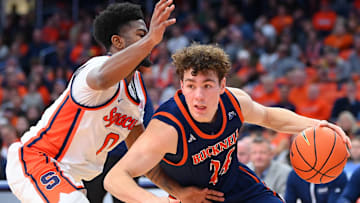 Dec 28, 2024; Syracuse, New York, USA; Bucknell Bison guard Achile Spadone (24) drives to the basket as Syracuse Orange guard Kyle Cuffe Jr. (0) defends during the second half at the JMA Wireless Dome. Mandatory Credit: Rich Barnes-Imagn Images