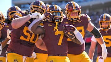 Sep 27, 2025; Minneapolis, Minnesota, USA;  Minnesota Golden Gophers running back Fame Ijeboi (7) celebrates his two-yard touchdown run against Rutgers Scarlet Knights with offensive linemen Nathan Roy (50) and Tony Nelson (59) during the second quarter at Huntington Bank Stadium.