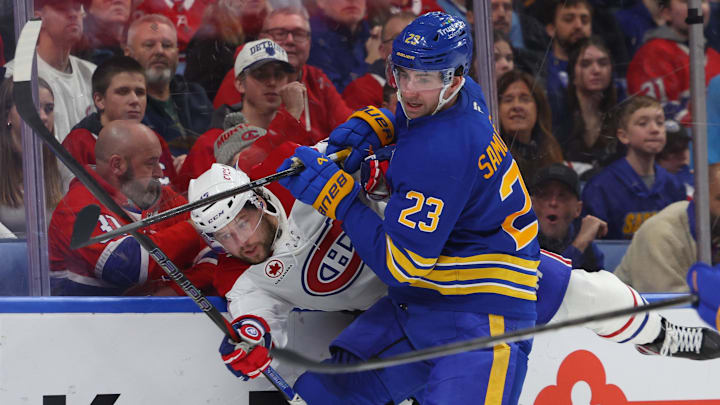 Jan 31, 2026; Buffalo, New York, USA;  Buffalo Sabres defenseman Mattias Samuelsson (23) checks Montréal Canadiens right wing Josh Anderson (17) as they go after a loose puck during the third period at KeyBank Center. Mandatory Credit: Timothy T. Ludwig-Imagn Images