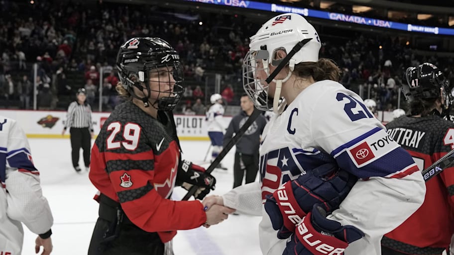 Marie Philip Poulin and Hilary Knight shake hands after a game