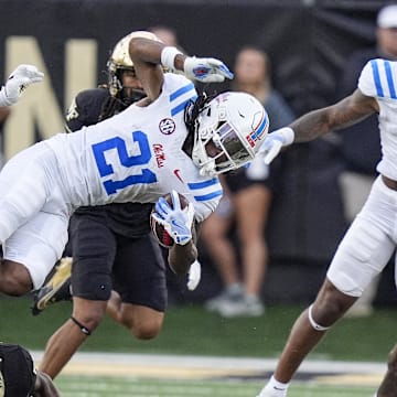 Sep 14, 2024; Winston-Salem, North Carolina, USA; Wake Forest Demon Deacons defensive back Evan Slocum (7) tackles Mississippi Rebels running back Henry Parrish Jr. (21) during the first half at Allegacy Federal Credit Union Stadium. Mandatory Credit: Jim Dedmon-Imagn Images