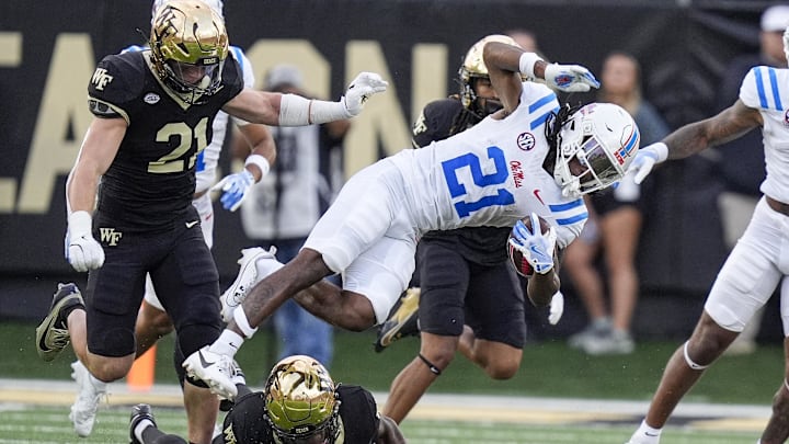 Sep 14, 2024; Winston-Salem, North Carolina, USA; Wake Forest Demon Deacons defensive back Evan Slocum (7) tackles Mississippi Rebels running back Henry Parrish Jr. (21) during the first half at Allegacy Federal Credit Union Stadium. Mandatory Credit: Jim Dedmon-Imagn Images