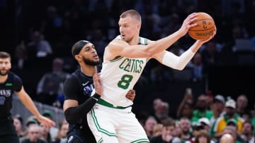 Jun 6, 2024; Boston, Massachusetts, USA; Boston Celtics center Kristaps Porzingis (8) controls the ball against Dallas Mavericks center Daniel Gafford (21) in the first quarter during game one of the 2024 NBA Finals at TD Garden. Mandatory Credit: David Butler II-USA TODAY Sports