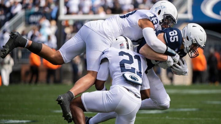 Penn State linebacker Tony Rojas (14) tackles tight end Luke Reynolds during the 2024 Blue-White Game at Beaver Stadium.