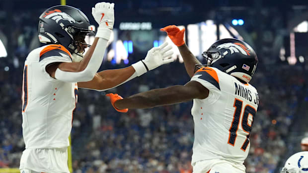 Denver Broncos wide receiver Devaughn Vele (81) and wide receiver Marvin Mims Jr. (19) celebrate a touchdown.