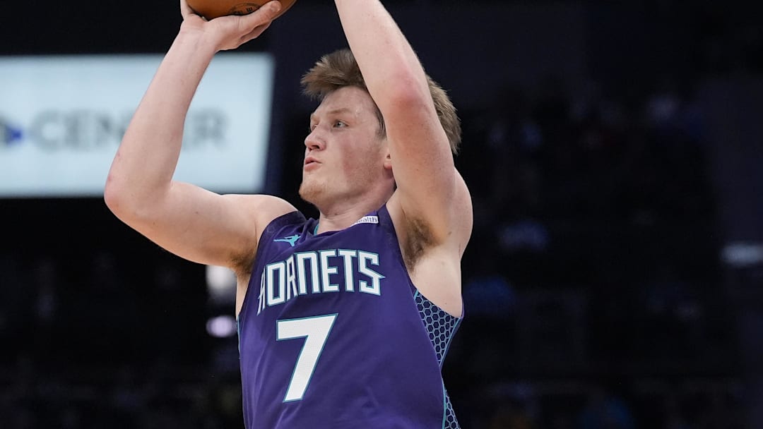 Dec 12, 2025; Charlotte, North Carolina, USA; Charlotte Hornets guard Kon Knueppel (7) shoots a three-pointer against Chicago Bulls forward Matas Buzelis (14) during the second quarter at Spectrum Center. Mandatory Credit: Jim Dedmon-Imagn Images
