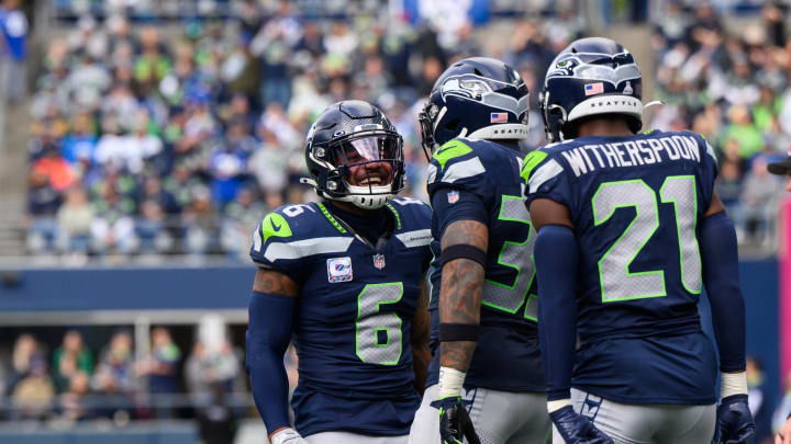 Oct 22, 2023; Seattle, Washington, USA; Seattle Seahawks safety Quandre Diggs (6) and safety Jamal Adams (33) and cornerback Devon Witherspoon (21) celebrate after the defense made a play against the Arizona Cardinals during the second half at Lumen Field. Mandatory Credit: Steven Bisig-USA TODAY Sports