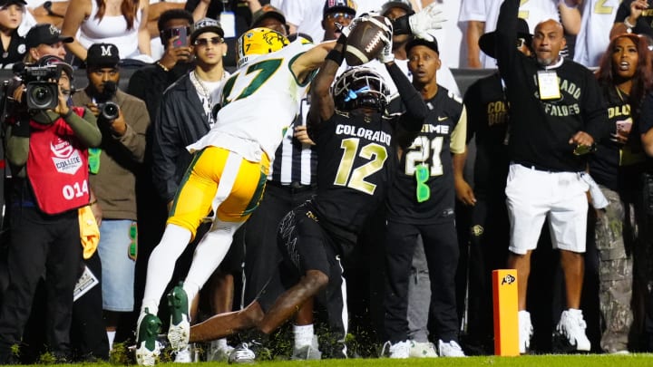 Aug 29, 2024; Boulder, Colorado, USA; Colorado Buffaloes wide receiver Travis Hunter (12) pulls in a touchdown reception past North Dakota State Bison cornerback Jailen Duffie (17) in the second half at Folsom Field. Mandatory Credit: Ron Chenoy-USA TODAY Sports