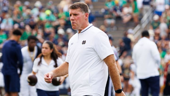 Notre Dame defensive coordinator Chris Ash walks the field before a NCAA football game against Purdue at Notre Dame Stadium on Saturday, Sept. 20, 2025, in South Bend.