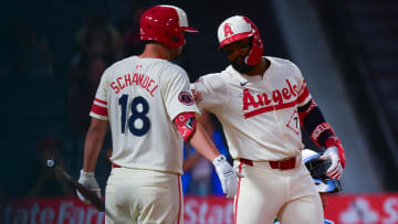 Aug 12, 2024; Anaheim, California, USA; Los Angeles Angels right fielder Jo Adell (7) is greeted by first baseman Nolan Schanuel (18) after hitting a solo home run against the Toronto Blue Jays during the ninth inning at Angel Stadium. Mandatory Credit: Gary A. Vasquez-USA TODAY Sports