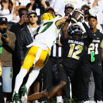 Aug 29, 2024; Boulder, Colorado, USA; Colorado Buffaloes wide receiver Travis Hunter (12) pulls in a touchdown reception past North Dakota State Bison cornerback Jailen Duffie (17) in the second half at Folsom Field.