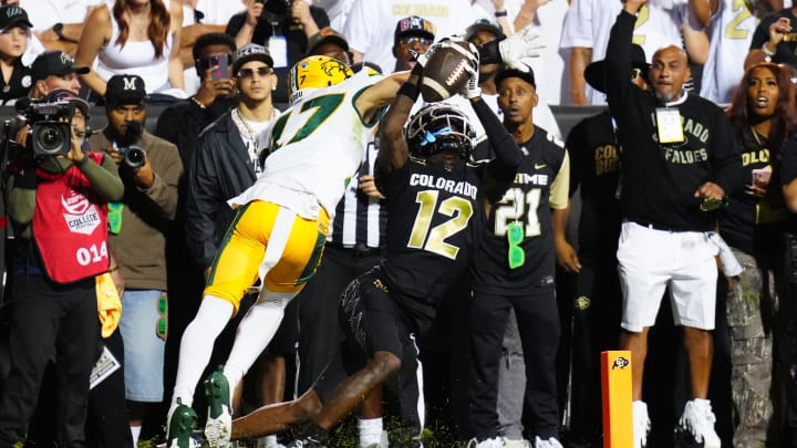 Aug 29, 2024; Boulder, Colorado, USA; Colorado Buffaloes wide receiver Travis Hunter (12) pulls in a touchdown reception past North Dakota State Bison cornerback Jailen Duffie (17) in the second half at Folsom Field.