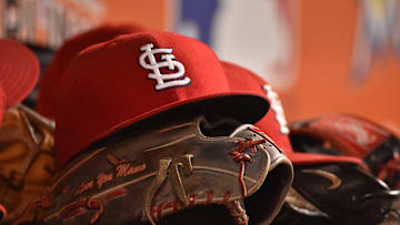 Jul 29, 2016; Miami, FL, USA; A detailed view of a hat and glove in the dugout of the St. Louis Cardinals in the game against the Miami Marlins at Marlins Park. The Cardinals defeated the Marlins 11-6. Mandatory Credit: Jasen Vinlove-Imagn Images
