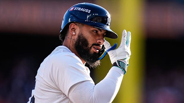 Detroit Tigers second baseman Gleyber Torres celebrates wearing a white jersey and navy blue helmet.
