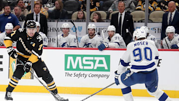 Nov 19, 2024; Pittsburgh, Pennsylvania, USA;  Pittsburgh Penguins center Evgeni Malkin (71) skates up ice with the puck as Tampa Bay Lightning defenseman J.J. Moser (90) defends during the third period at PPG Paints Arena. Mandatory Credit: Charles LeClaire-Imagn Images