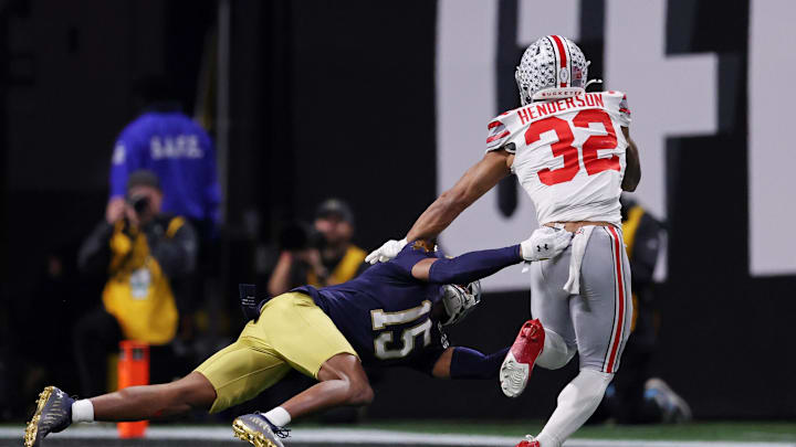 Jan 20, 2025; Atlanta, GA, USA; Notre Dame Fighting Irish cornerback Leonard Moore (15) attempts to tackle Ohio State Buckeyes running back TreVeyon Henderson (32) during the second half the CFP National Championship college football game at Mercedes-Benz Stadium. Mandatory Credit: Brett Davis-Imagn Images
