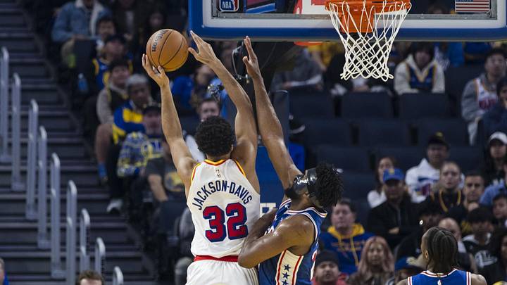 Jan 2, 2025; San Francisco, California, USA; Philadelphia 76ers center Joel Embiid (21) defends a shot by Golden State Warriors forward Trayce Jackson-Davis (32) during the first quarter at Chase Center. Mandatory Credit: John Hefti-Imagn Images