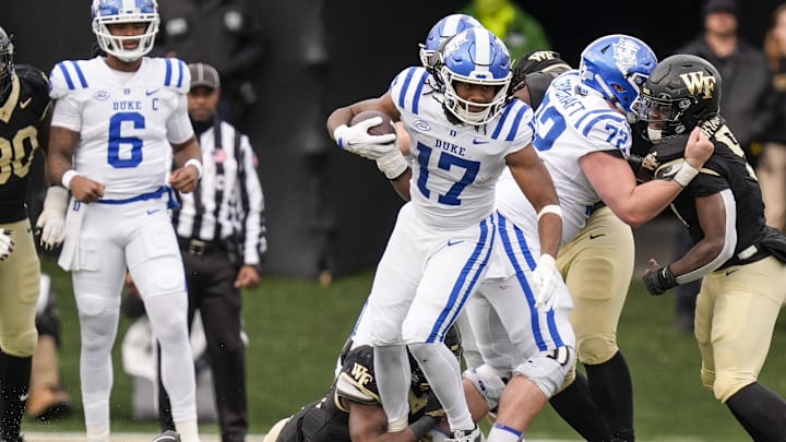Nov 30, 2024; Winston-Salem, North Carolina, USA; Wake Forest Demon Deacons defensive back Davaughn Patterson (13) tries to tackle Duke Blue Devils running back Star Thomas (17) during the second half at Allegacy Federal Credit Union Stadium. Mandatory Credit: Jim Dedmon-Imagn Images