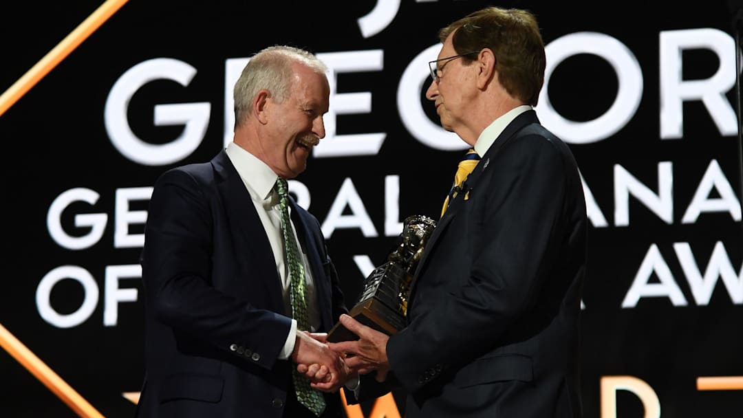 Jun 28, 2023; Nashville, Tennessee, USA; Dallas Stars general manager Jim Nill is awarded the Jim Gregory General Manager of the Year award by Nashville Predators general manager David Poile during the first round of the 2023 NHL Draft at Bridgestone Arena. Mandatory Credit: Christopher Hanewinckel-Imagn Images