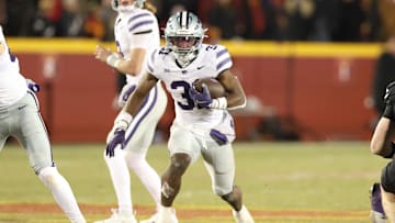 Nov 30, 2024; Ames, Iowa, USA;  Kansas State Wildcats running back DJ Giddens (31) runs the football against the Iowa State Cyclones in the first quarter at at Jack Trice Stadium. Mandatory Credit: Reese Strickland-Imagn Images