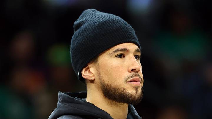 Feb 24, 2026; Phoenix, Arizona, USA; Phoenix Suns injured guard Devin Booker against the Boston Celtics in the second half at Mortgage Matchup Center. Mandatory Credit: Mark J. Rebilas-Imagn Images