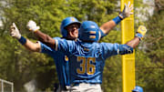 UCLA’s Dean West, left, celebrates his first inning home run with teammate Roman Martin at PK Park in Eugene.