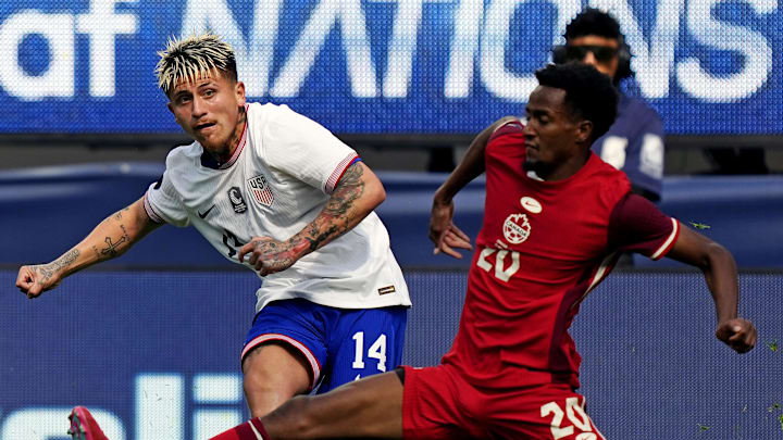 Diego Luna (left) plays in a cross with Canada's Ali Ahmed (right) contesting in the Concacaf Nations League third place match.