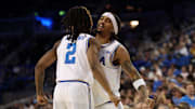 Jan 21, 2025; Los Angeles, California, USA;  UCLA Bruins guard Skyy Clark (55) chest bumps with guard Dylan Andrews (2) during the second half against the Wisconsin Badgers at Pauley Pavilion presented by Wescom. Mandatory Credit: Kiyoshi Mio-Imagn Images
