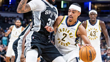 Oct 13, 2025; Indianapolis, Indiana, USA;Indiana Pacers guard/forward Andrew Nembhard (2) dribbles the ball while San Antonio Spurs forward Julian Champagnie (30)  defends in the first half at Gainbridge Fieldhouse. Mandatory Credit: Trevor Ruszkowski-Imagn Images
